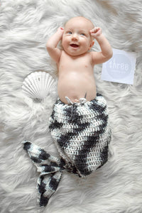 Baby with a black and white crochet mermaid tail
