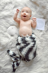 Baby with a black and white crochet mermaid tail