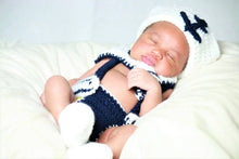 Baby with a crochet navy and white sailor outfit